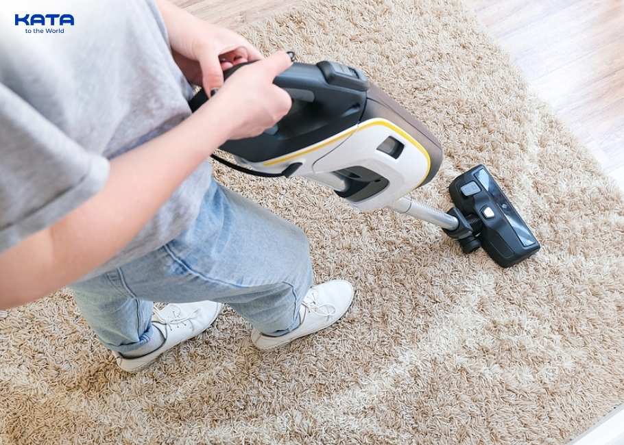 a person is vacuuming the carpet