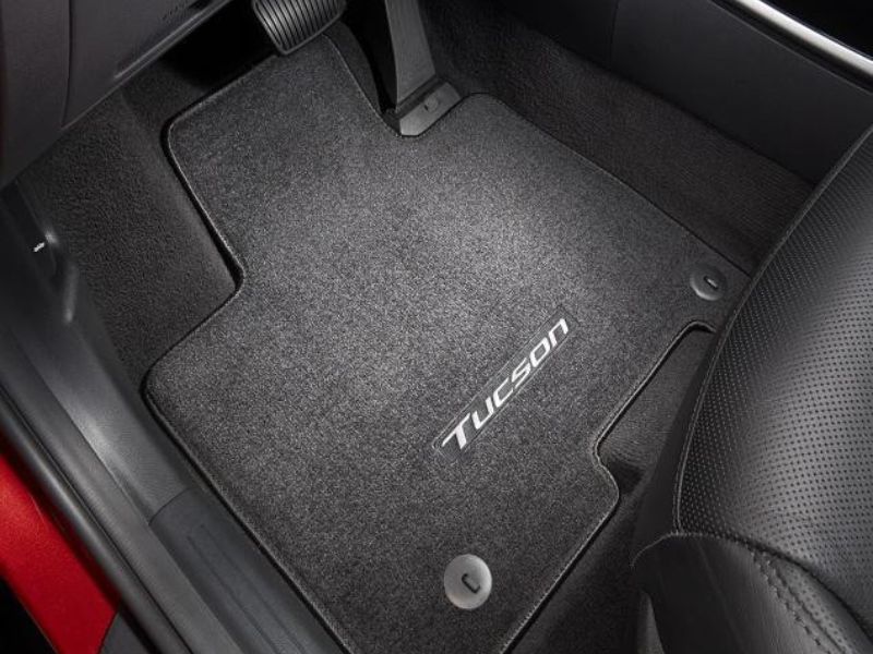 Close-up of original OEM car floor mats featuring a perfect factory fit.