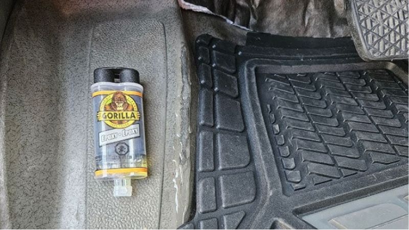 Worn and warped car floor mat made from low-quality recycled PVC.